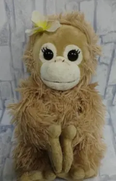 ベージュのサルのぬいぐるみ 花付き