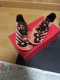 New Balance スパイクシューズ オレンジ/ブラック