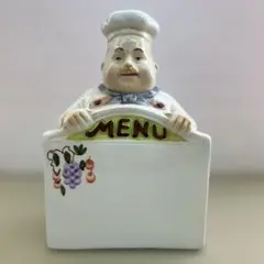 陶器製メニュープレートを持つシェフ
