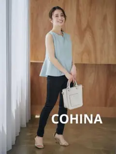 COHINAバックボタンサッカーペプラムブラウス