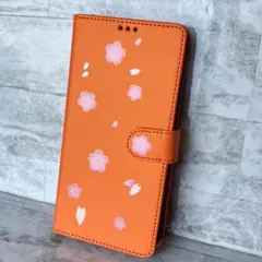 【iPhone12Pro】手帳型ケース 桜が舞う華やかなデザイン オレンジ