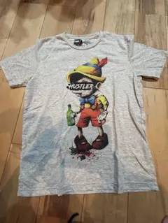 イーワンシンジゲートE1SYNDICATE ピノキオTシャツ