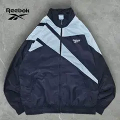 人気モノクロREEBOKナイロンジャケット 古着ビッグロゴ白黒 刺繍