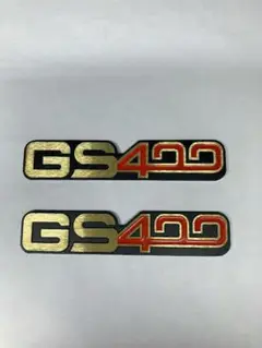 SUZUKI タンク エンブレムオーナメント2枚セット GT750GT380 SUZUKI タンクエンブレム 2枚セット gt380 - メルカリ