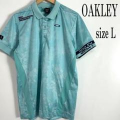《美品》OAKLEY オークリー スカル ロゴ刺繍 総柄 ポロ ゴルフウエア L