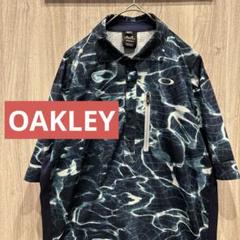 【美品】OAKLEY ゴルフウェア 総柄 半袖ポロシャツ 刺繍ロゴ 古着 L