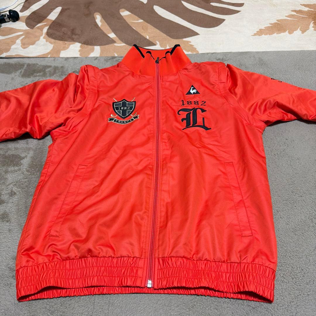 防寒具ルコックゴルフ オレンジジャケットM・le coq sportif