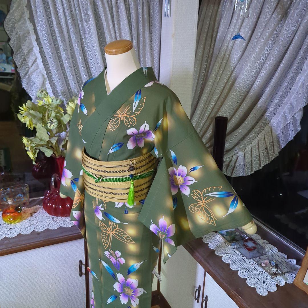 草緑の地にほんのりと入る暈しと、花や蝶が艶やかな注染めの浴衣です