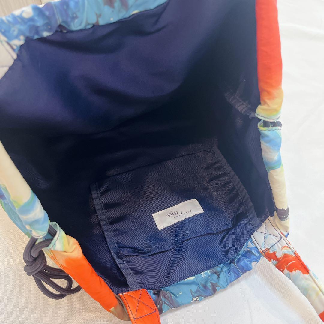 UN3D. REBORN DRAWSTRING BAG オレンジ トートバッグ