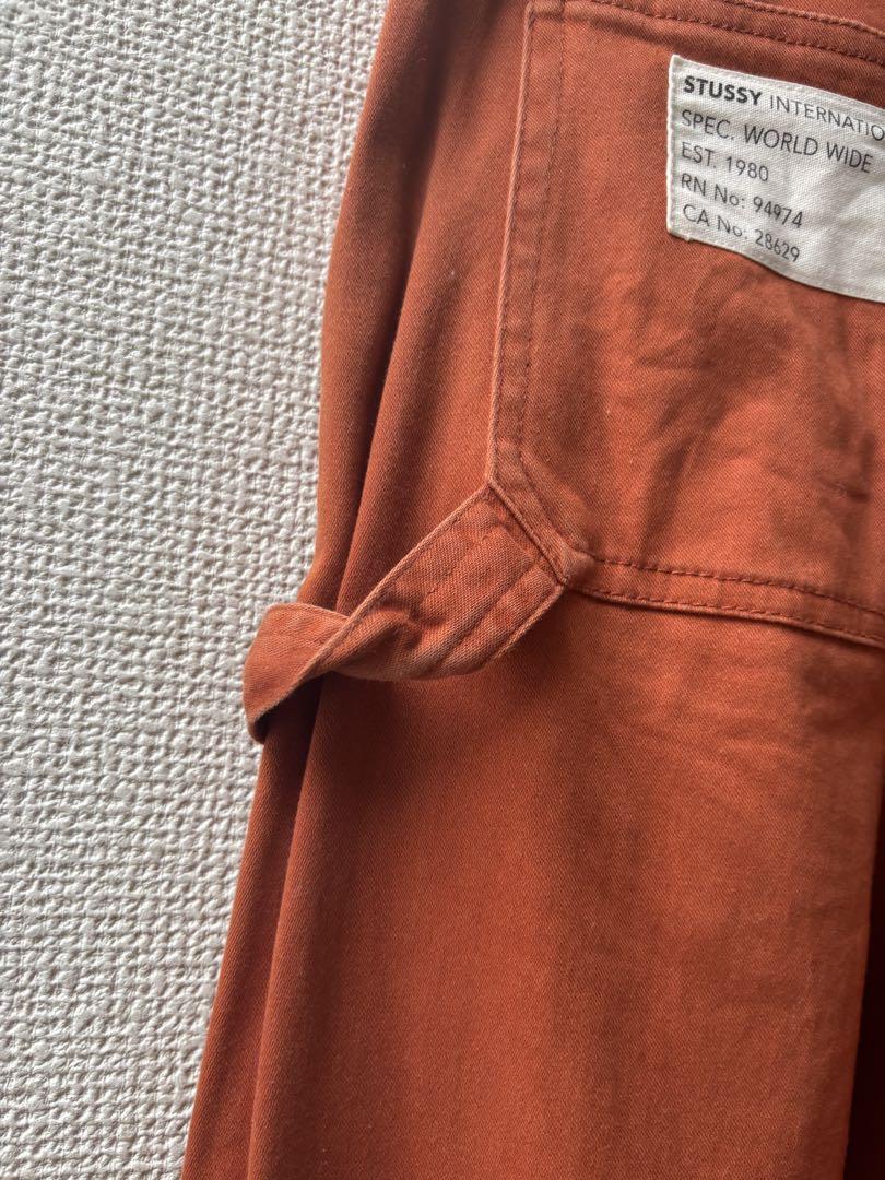 STUSSY オレンジ ワイドパンツ ポケット付き - メルカリ