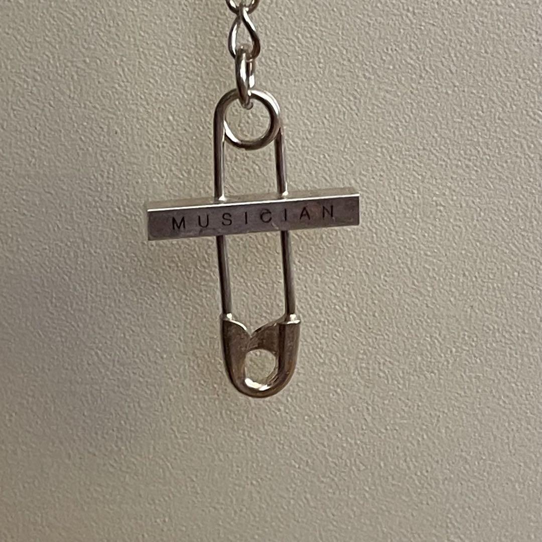 LAD MUSICIAN / SAFETY PIN CROSS NECKLACE
