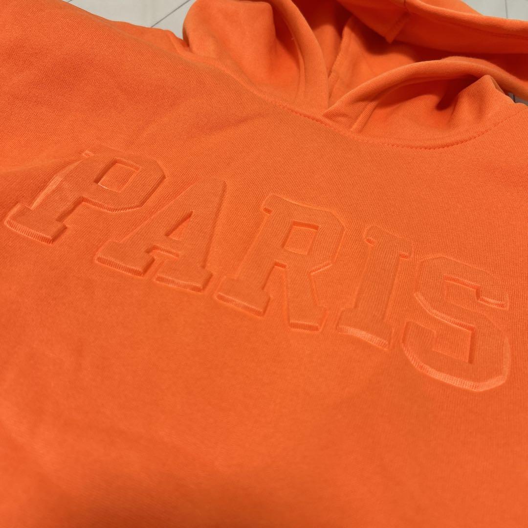 未使用XLオレンジ PARIS フード付きパーカー - メルカリ