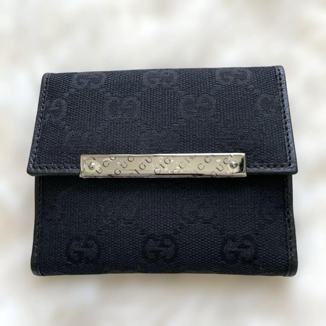GUCCI グッチ　二つ折り財布　シマ　総柄　型押しロゴ　キャンバス　レザー GUCCI レザー×キャンバス 二つ折り財布 GG総柄 型押し ロゴ