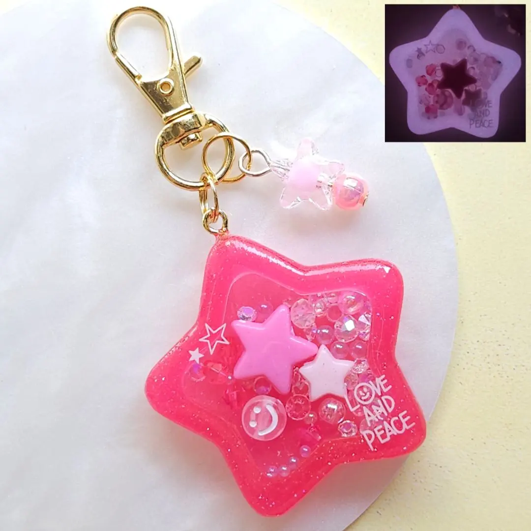 Thumbnail of Glow-in-the-dark pink star shaker keychain resin shaka shaka smiley face glows
