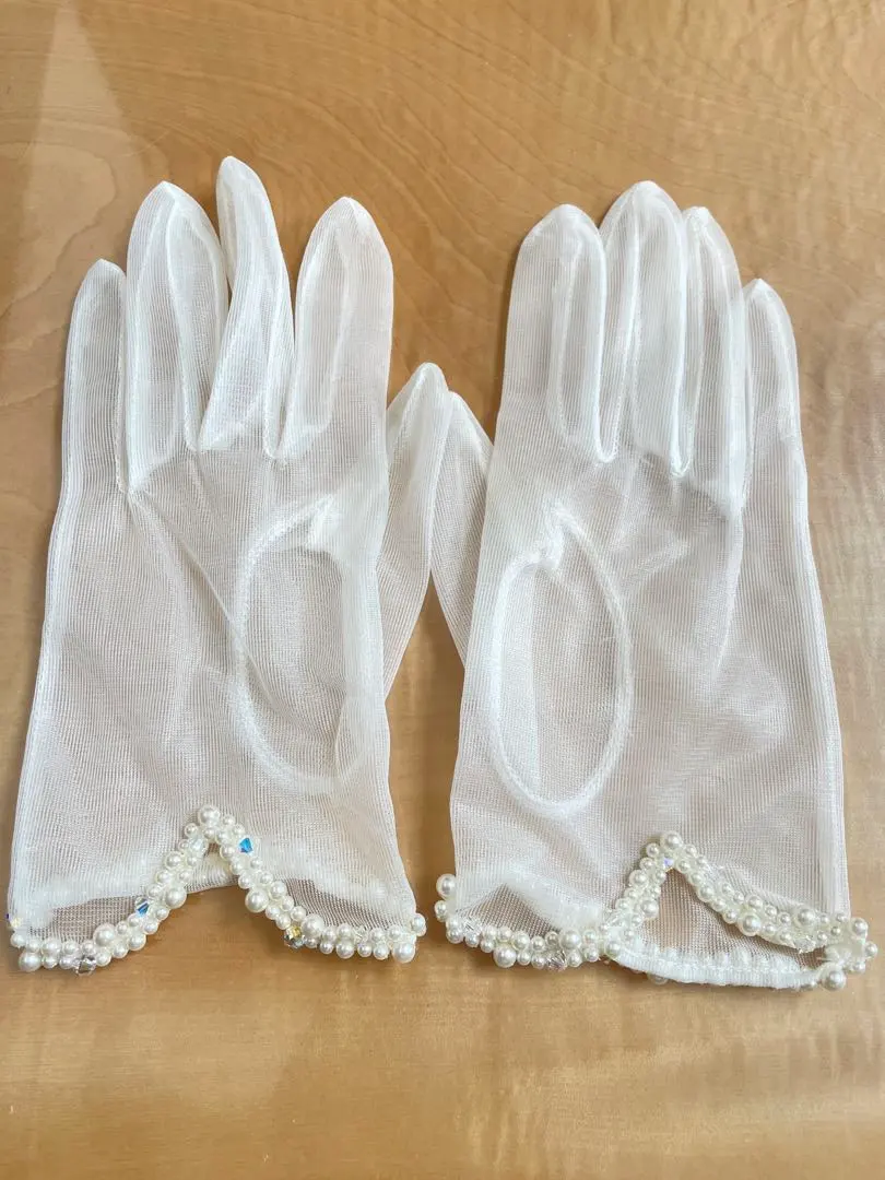 Thumbnail of White wedding gloves with pearl embellishments