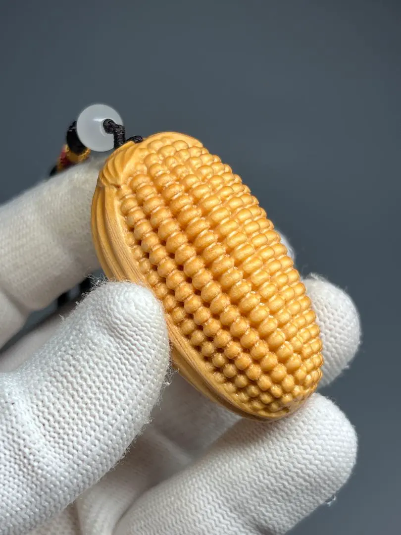 Thumbnail of Wooden, finely carved corn netsuke, made of cliff cypress wood, with a strap, hanging ornament