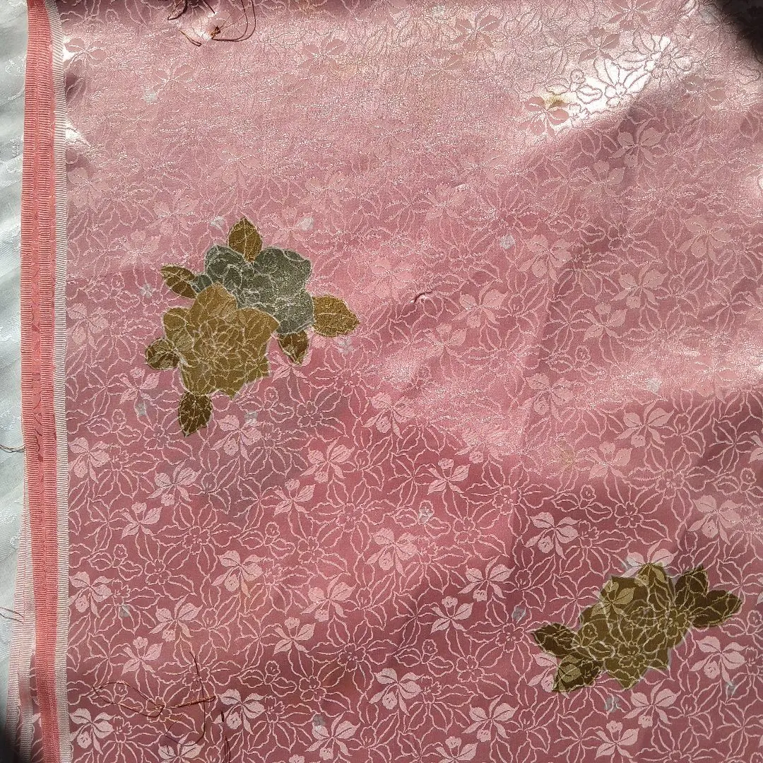 Thumbnail of Pink fabric scraps with a floral pattern