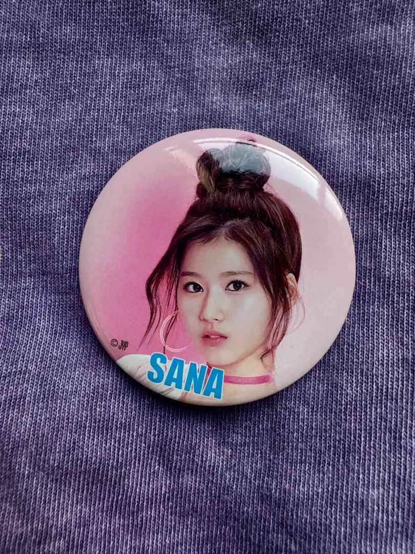 Thumbnail of SANA pin badge, approximately 5cm in diameter