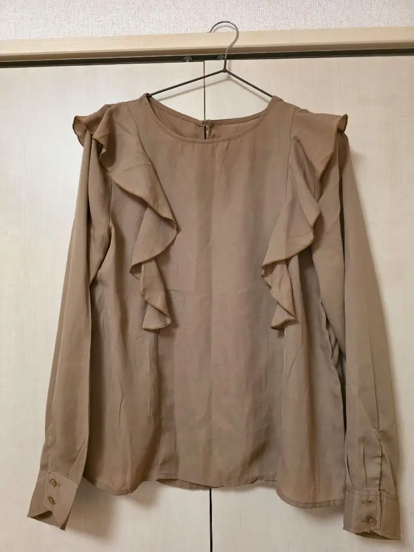 Thumbnail of Beige long-sleeved blouse with frills