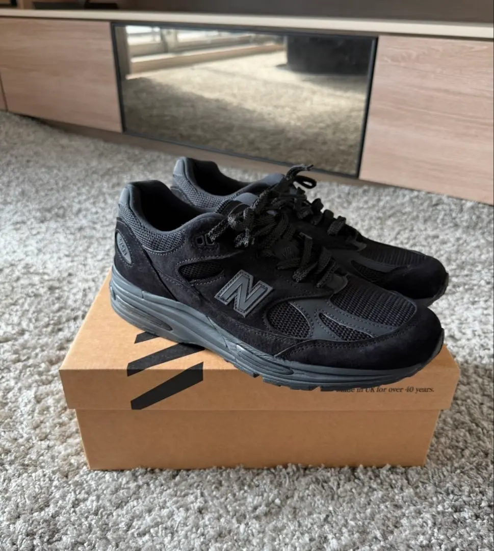 Thumbnail of New Balance 991v2 all-black sneakers