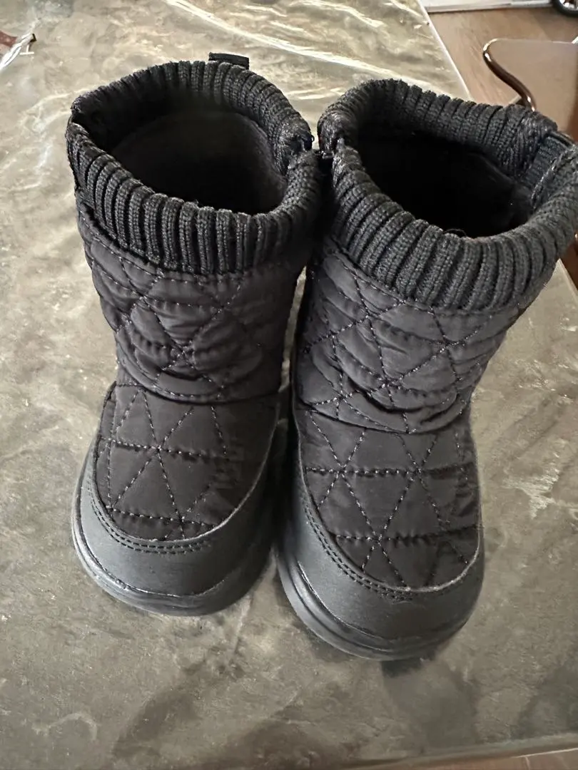 Thumbnail of Black quilted boots