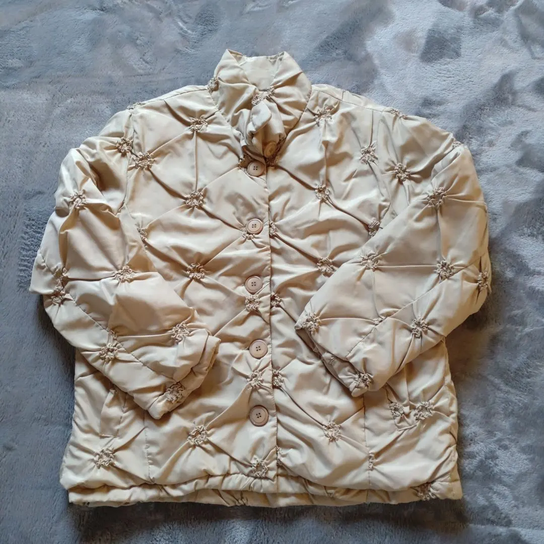 Thumbnail of Cream-colored quilted down jacket