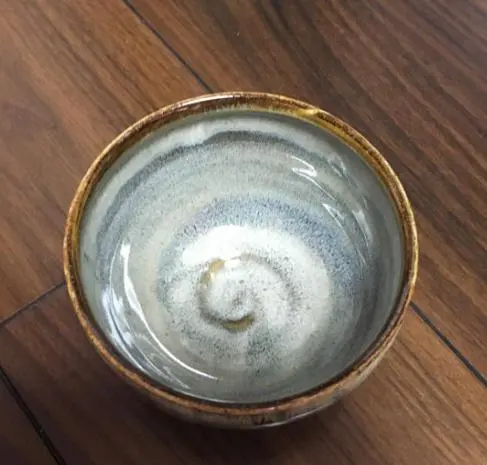 Thumbnail of A teacup with a blue and white swirling pattern
