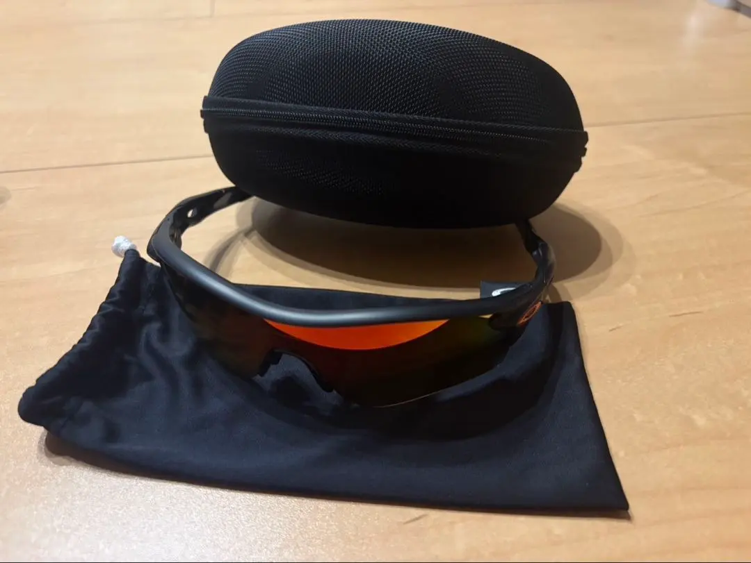 Thumbnail of Oakley sunglasses with orange lenses, with case