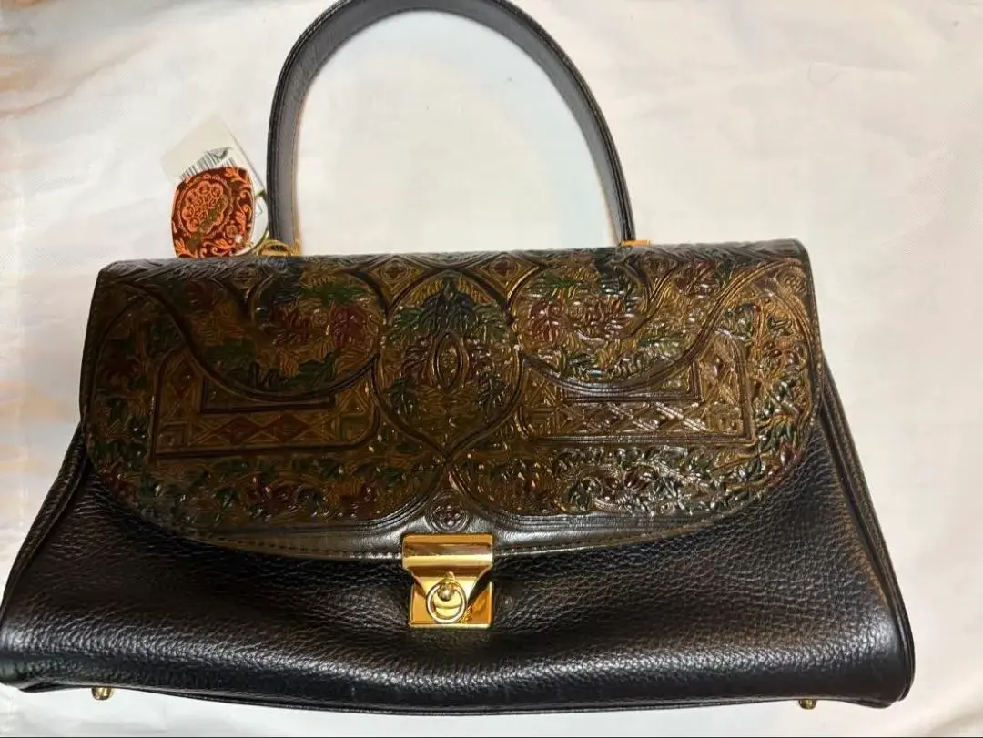 Thumbnail of Embossed black leather handbag