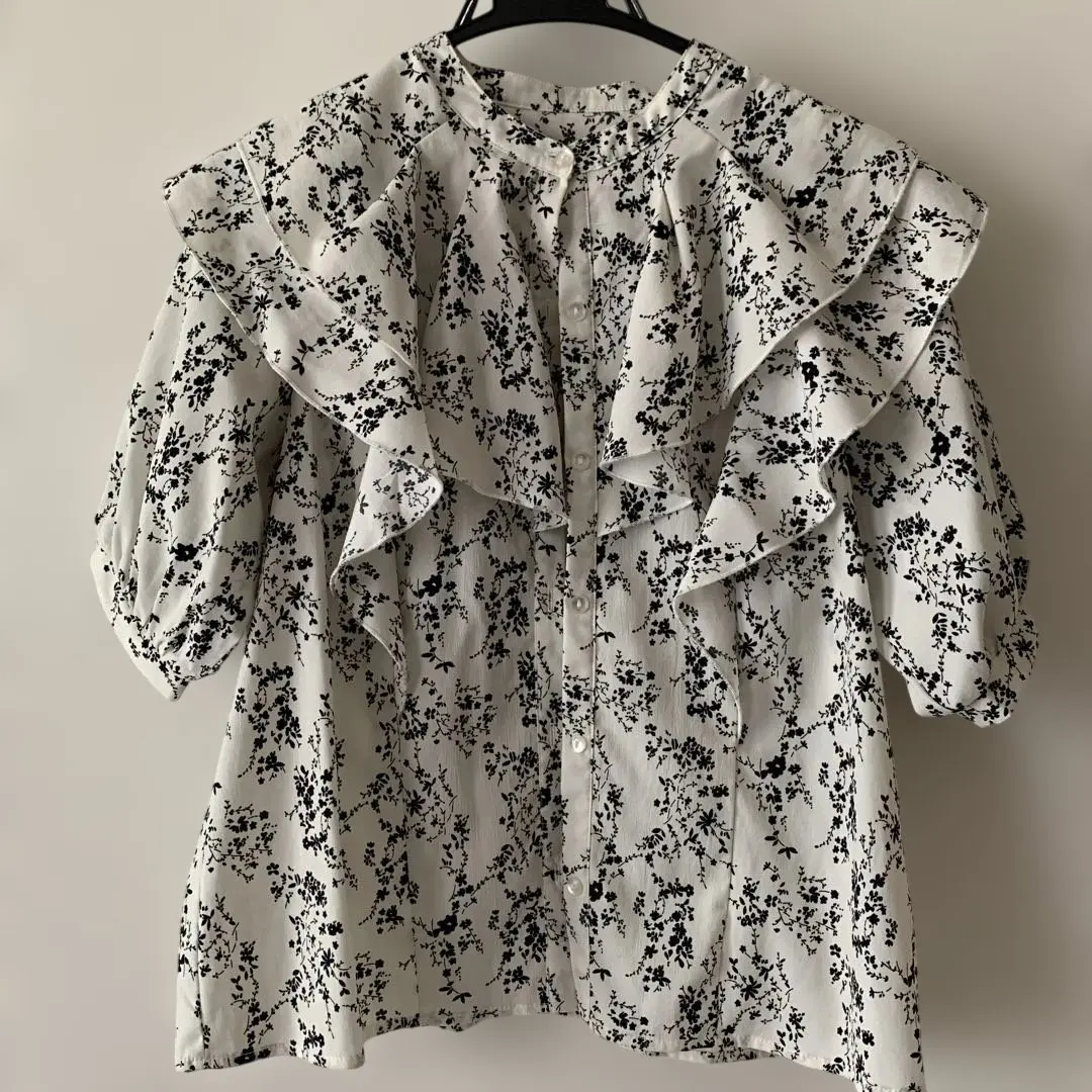 Thumbnail of White and black floral blouse with frills