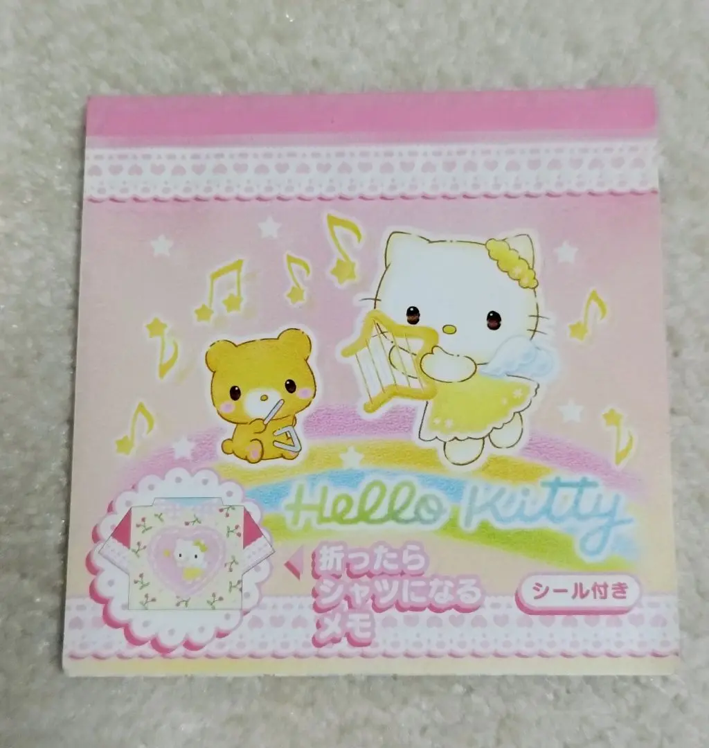 Thumbnail of Kitty Memo 2003 with seals, angel-themed memo pad that folds into a shirt