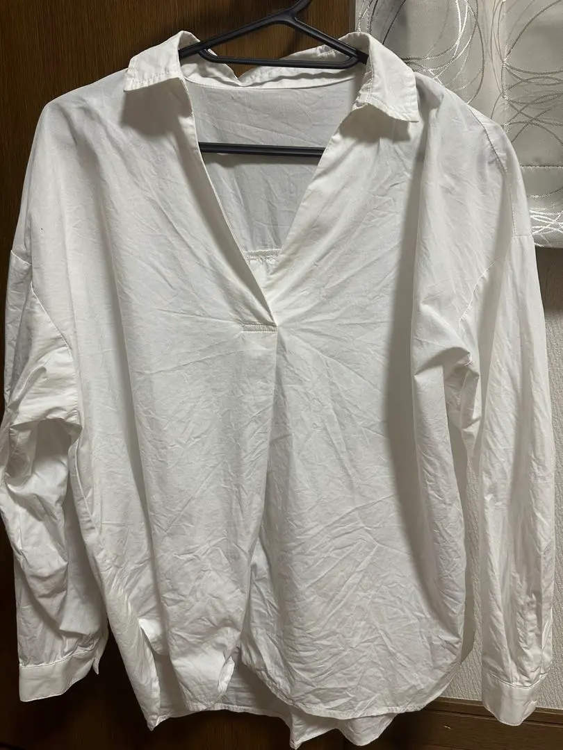 Thumbnail of White V-neck long-sleeved shirt