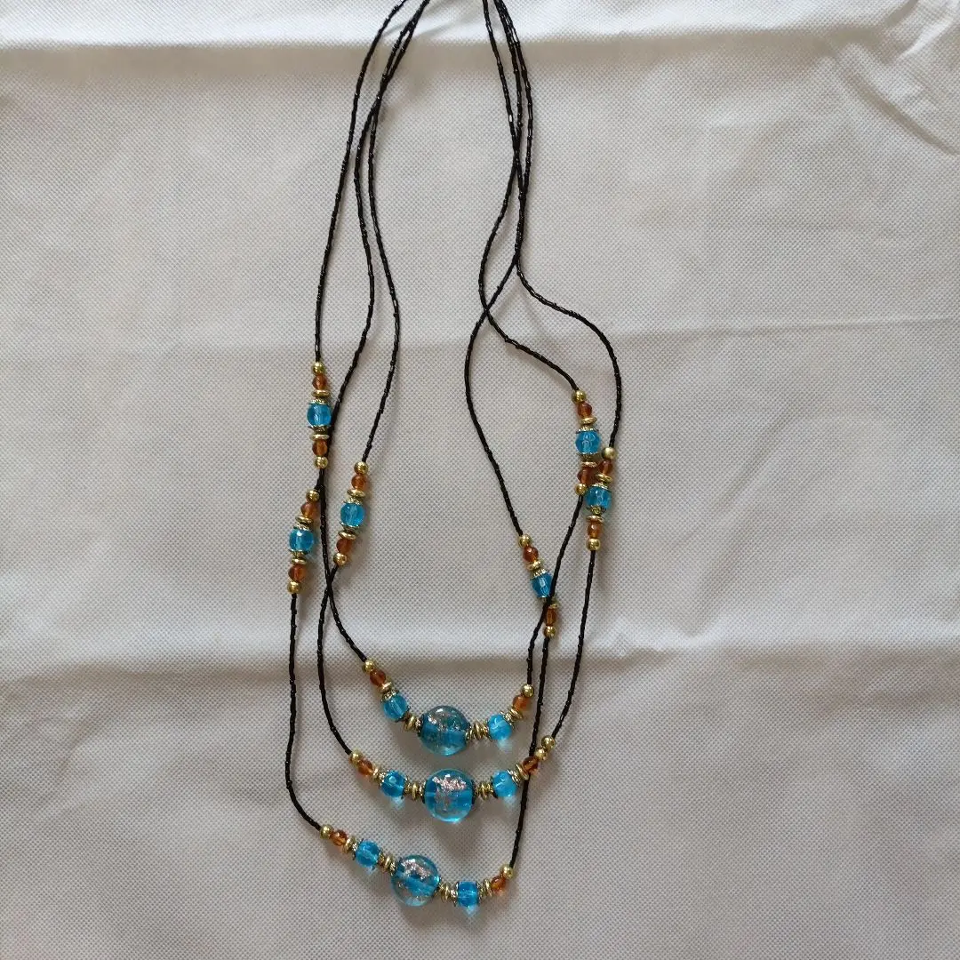 Thumbnail of Brand new, unused, long necklace with blue beads