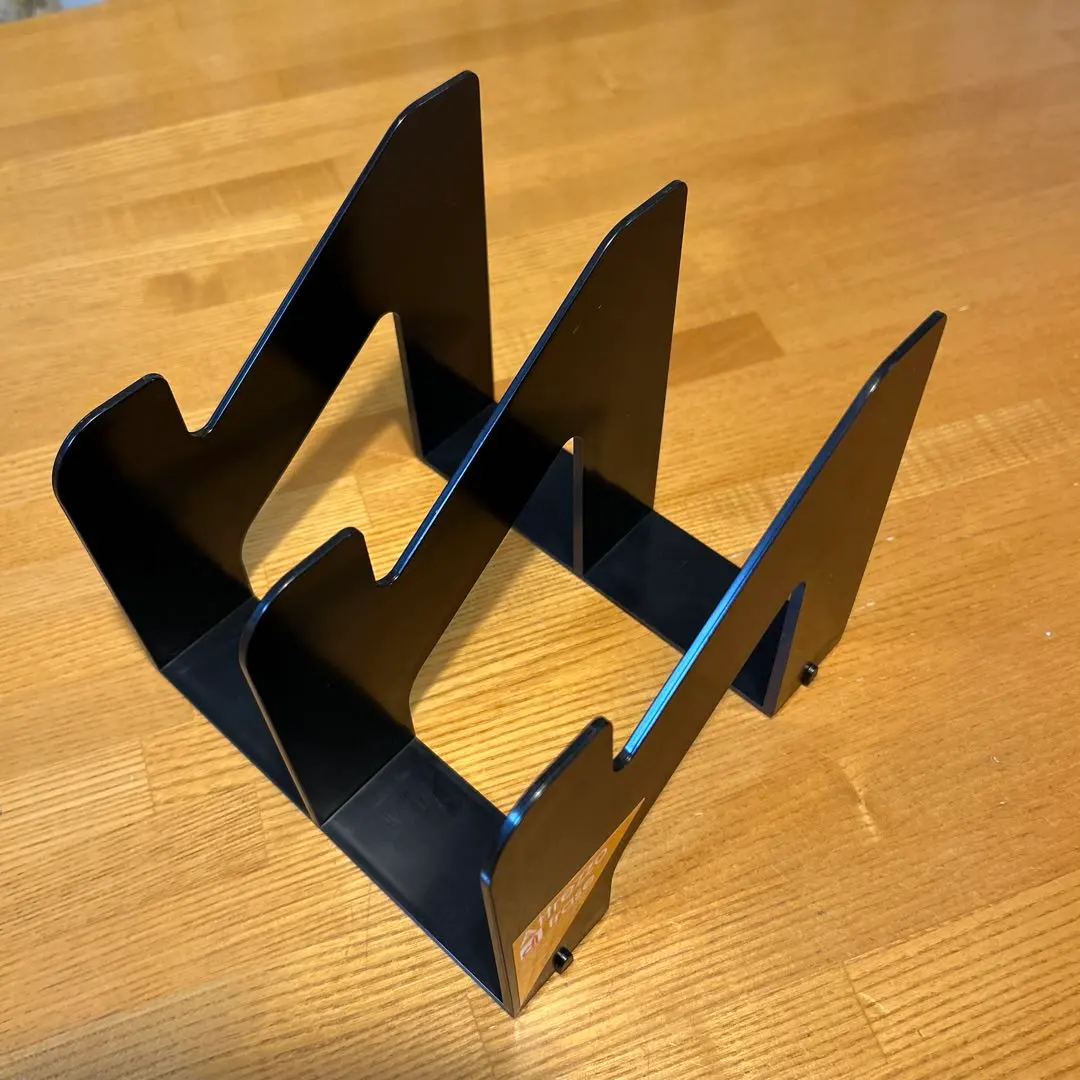 Thumbnail of Black plastic book stand, 16cm wide x 16cm deep x 14cm high