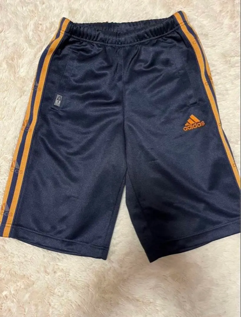 Thumbnail of Adidas track pants, 130cm, navy with orange stripes