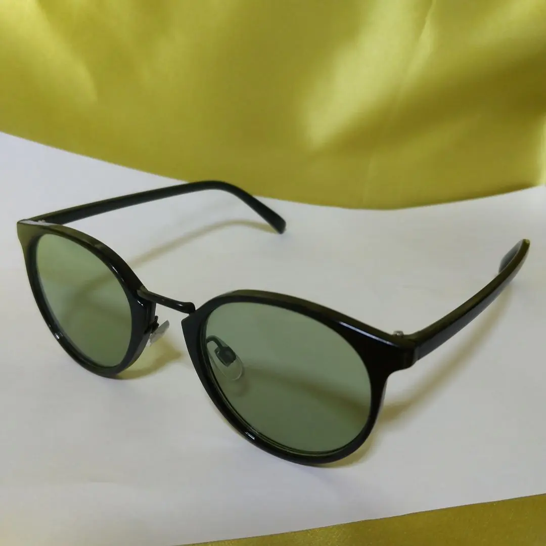 Thumbnail of Black round sunglasses with green lenses