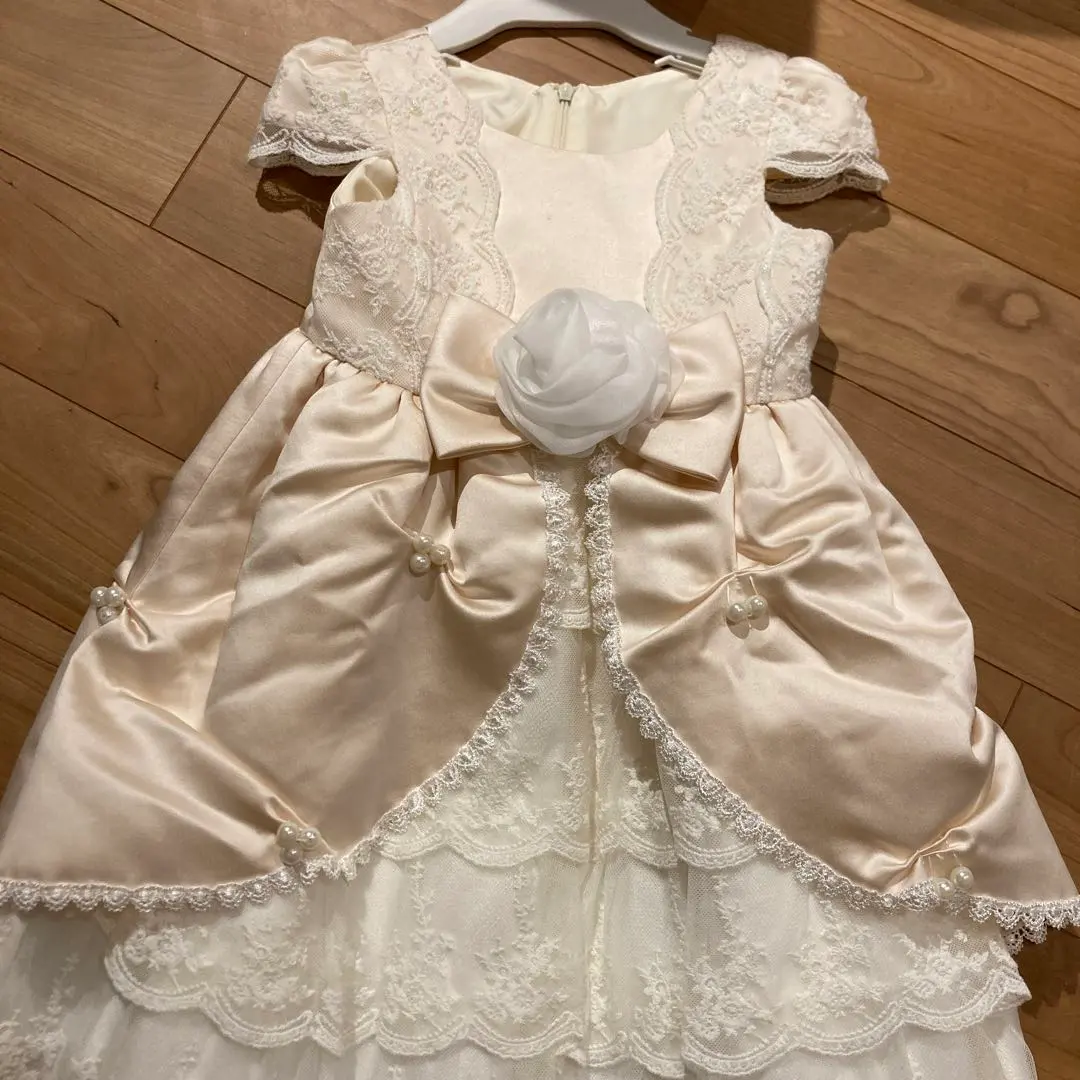 Thumbnail of Cream dress with flower decoration, 100cm