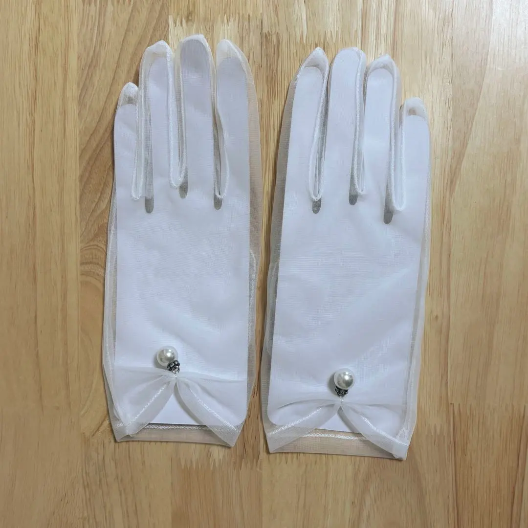 Thumbnail of White wedding gloves with pearl embellishments