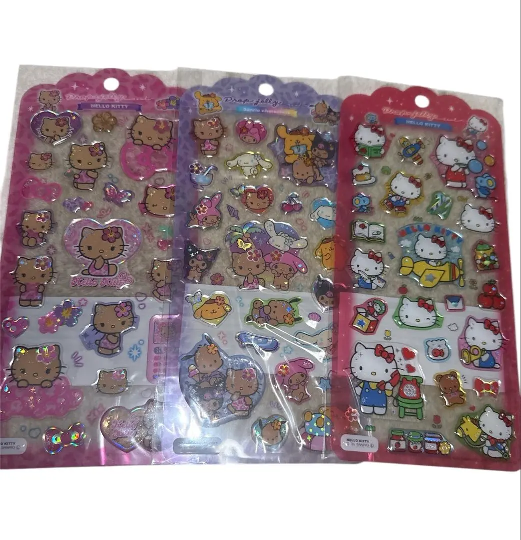 全新未使用 三麗鷗 Hello Kitty 曬黑Kitty 滴膠果凍貼紙 的縮圖