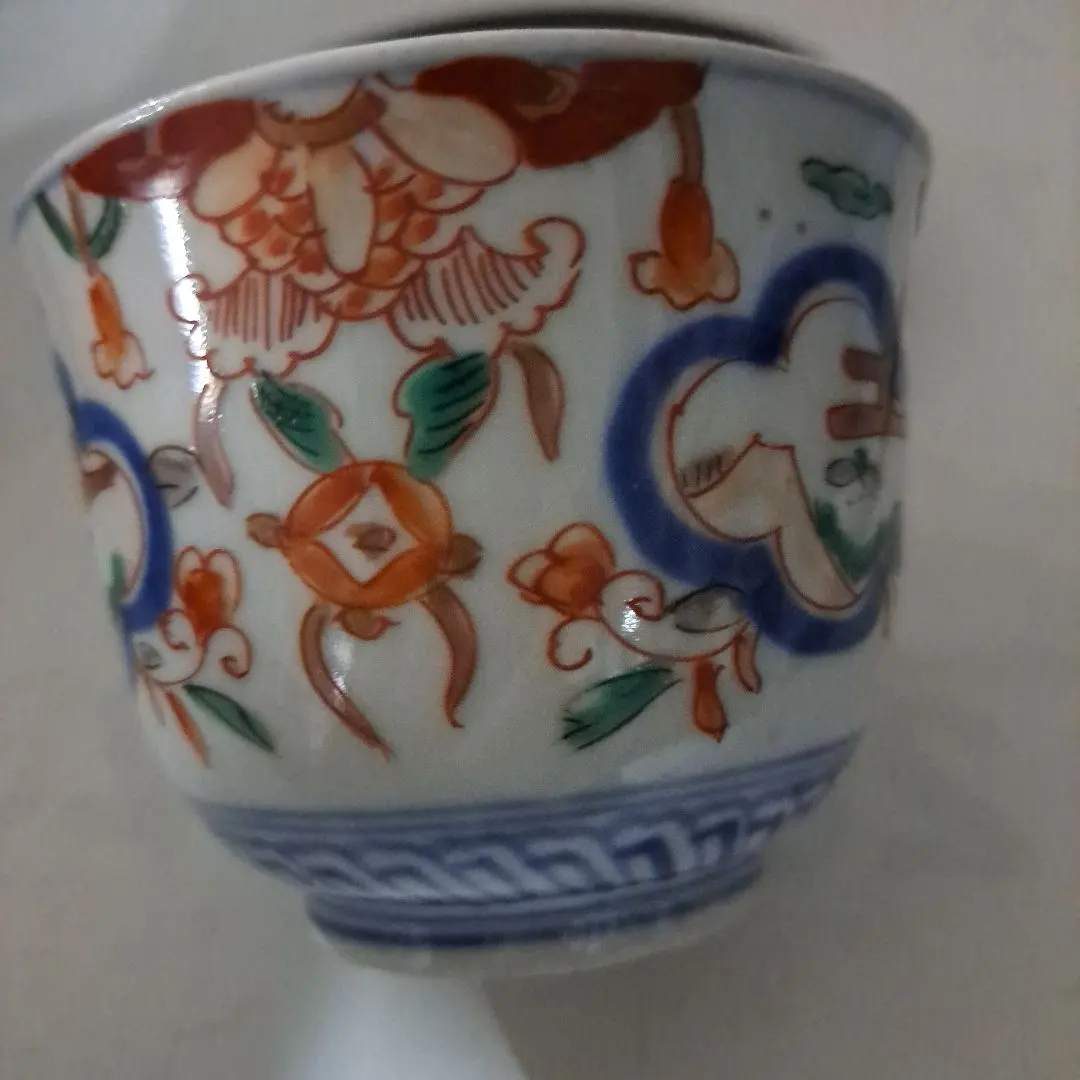 Thumbnail of Late Edo period, red-and-gold painted small cup (choko), featuring a Mount Fuji window design, with a high, comb-shaped foot.