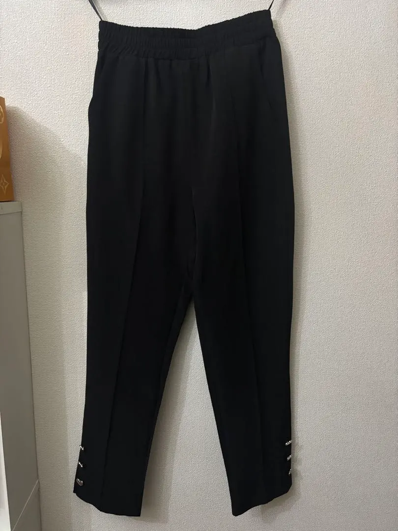 Thumbnail of Unworn black straight pants with heart-shaped buttons
