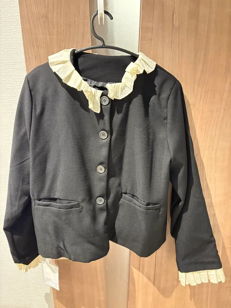 Thumbnail of Black women's stylish no-collar jacket with frills