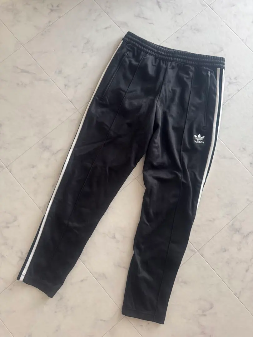 Thumbnail of Adidas black jersey pants with three stripes