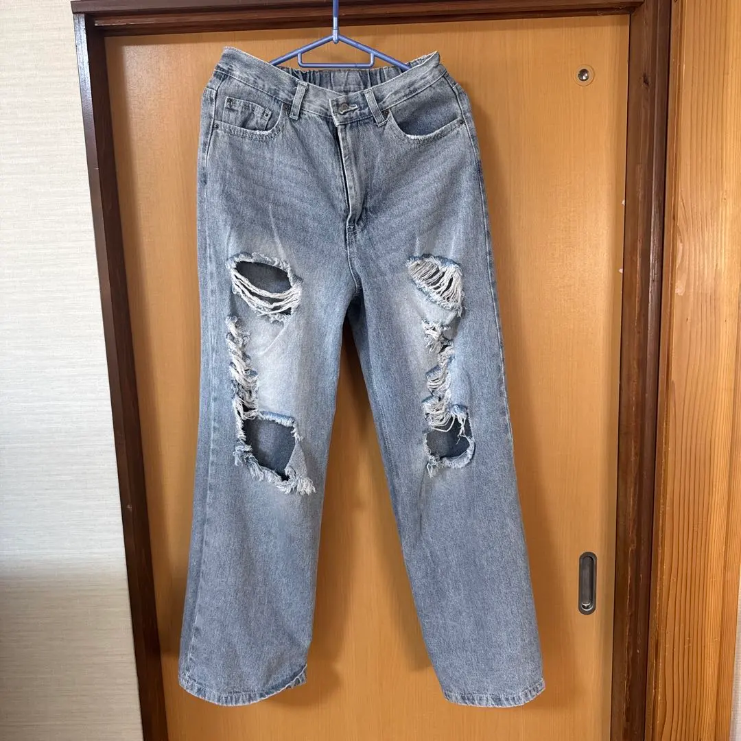 Thumbnail of Distressed light blue jeans