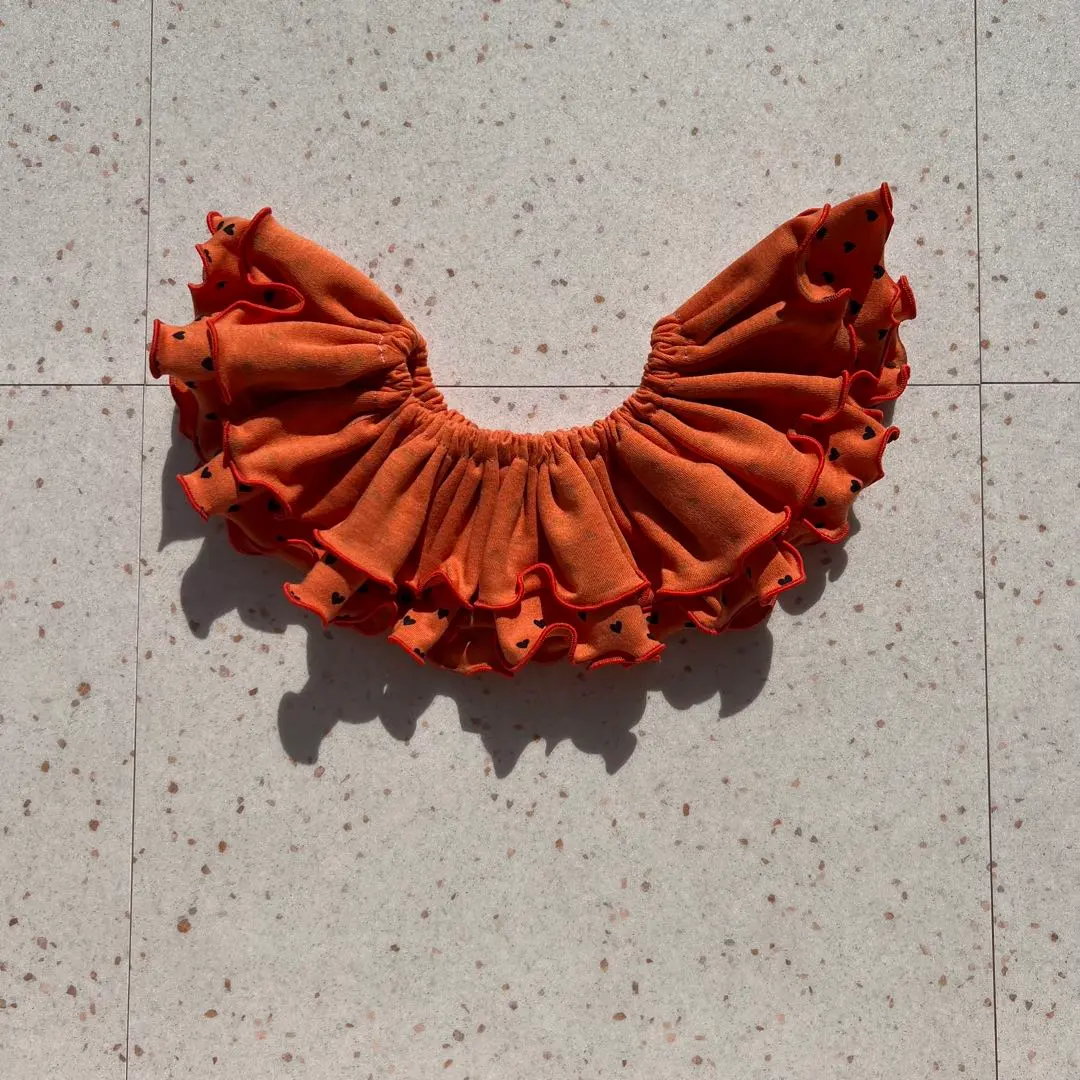 Thumbnail of Orange heart-patterned frilly bib