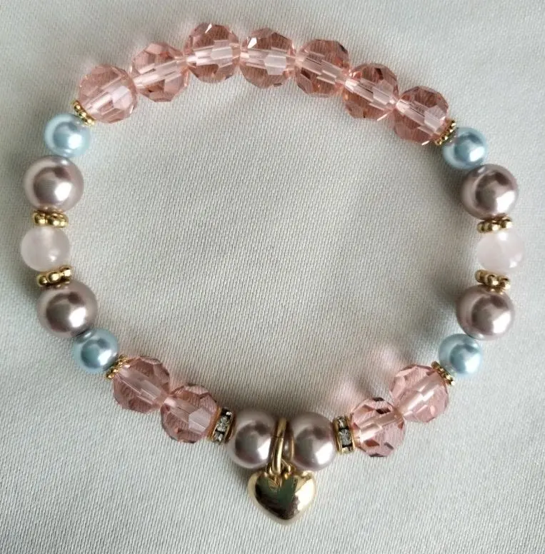 Thumbnail of Clear bracelet with pearls and crystals, pink tones, gold tones, heart charm