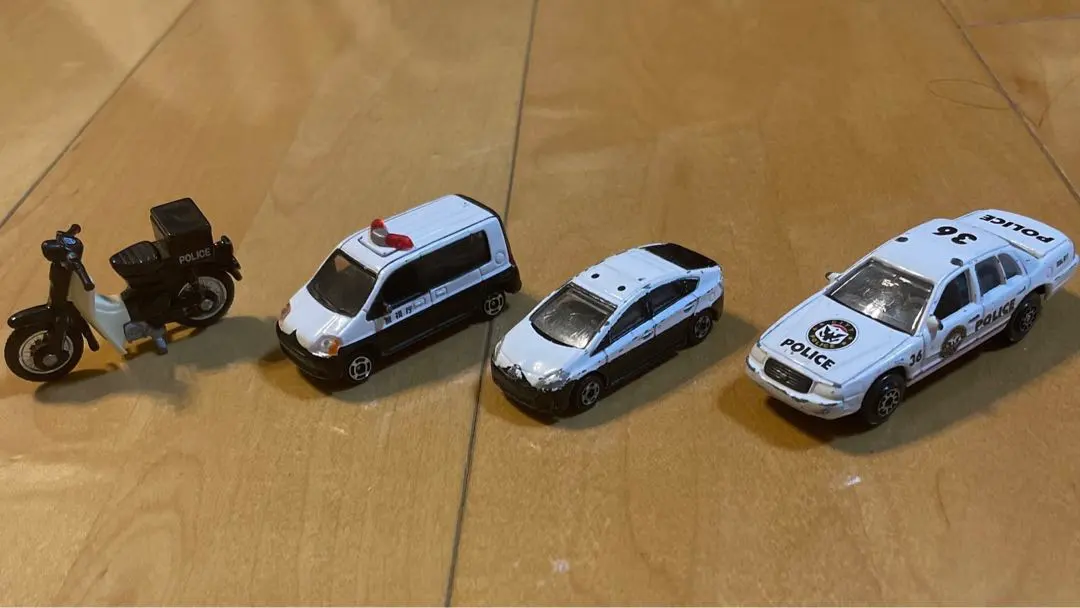Thumbnail of Miniature cars, including Tomica, police cars, and motorcycles
