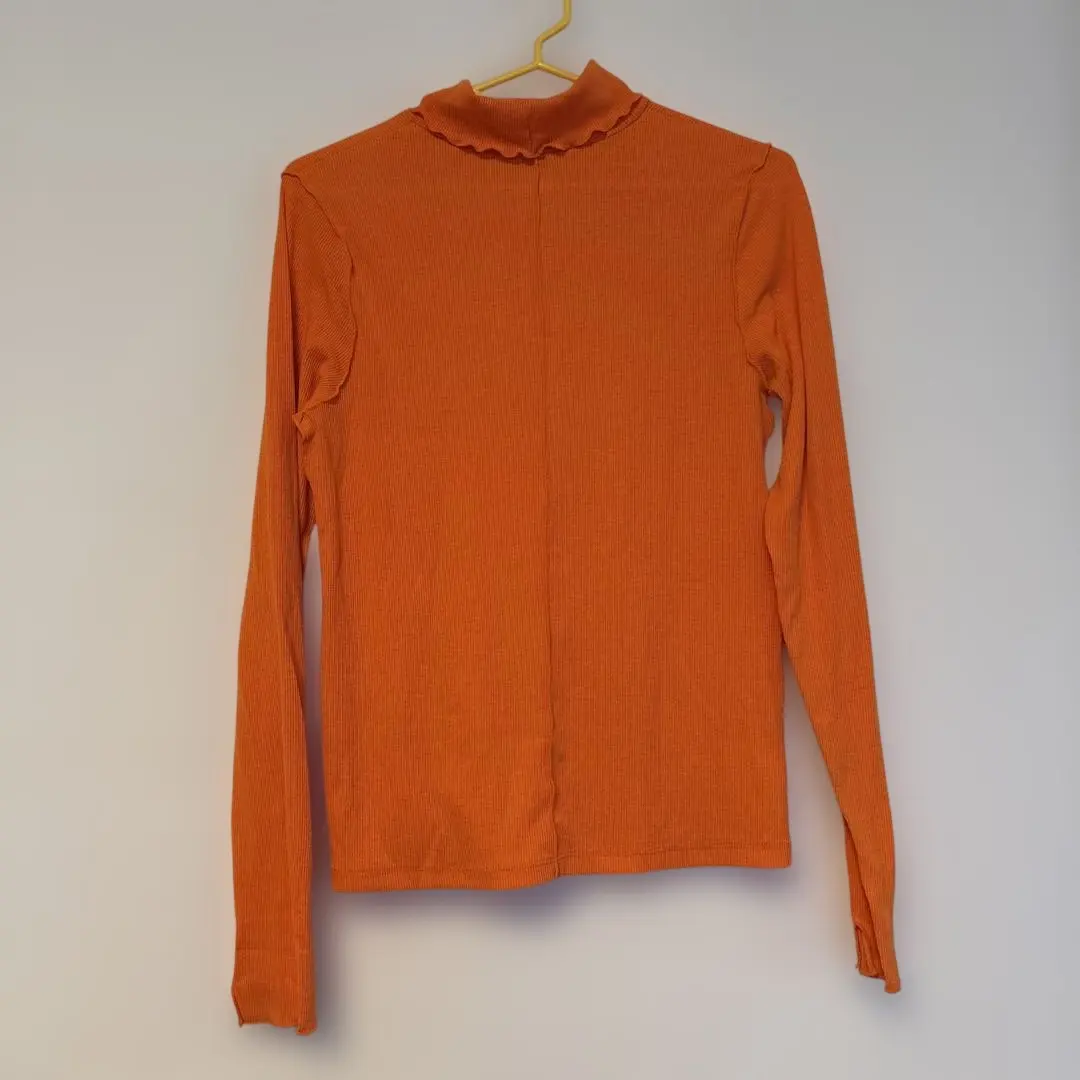 Thumbnail of Orange long-sleeved turtleneck top
