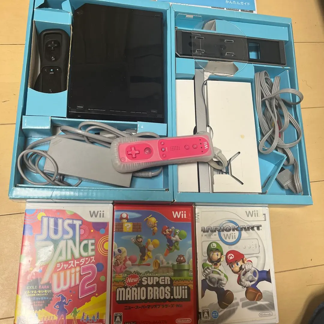Thumbnail of Wii console set + pink remote control, 3 game cartridges