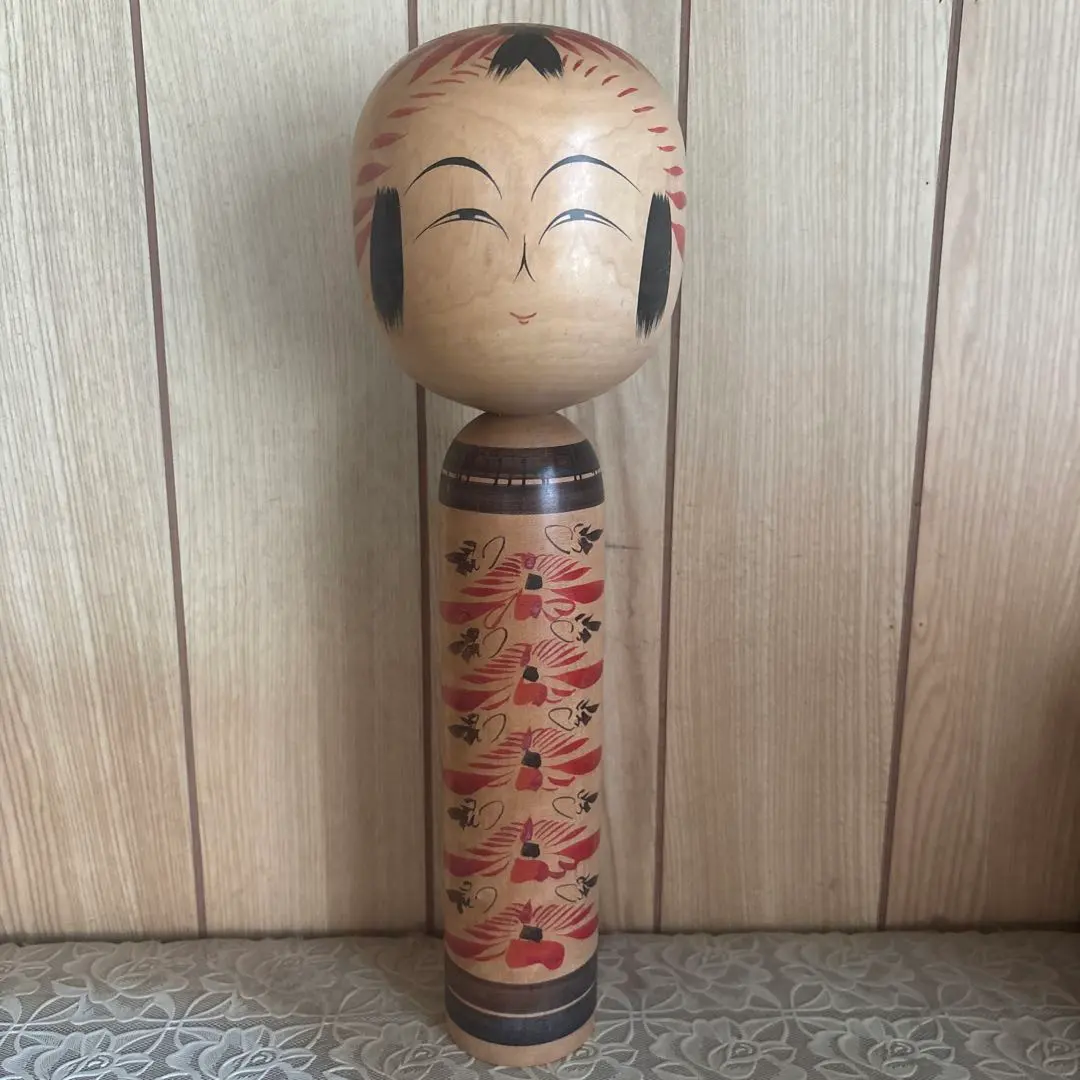 Thumbnail of Traditional wooden Kokeshi doll, red and black decorations, approximately 30cm